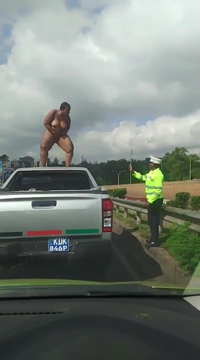 Crazy woman naked on top of a car on Thika Road, touching her BBW pussy and showing off her ass and boobs with police watching